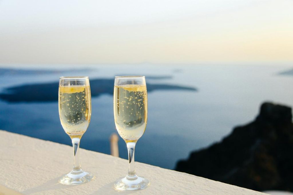 2 champaign glasses on a table with view