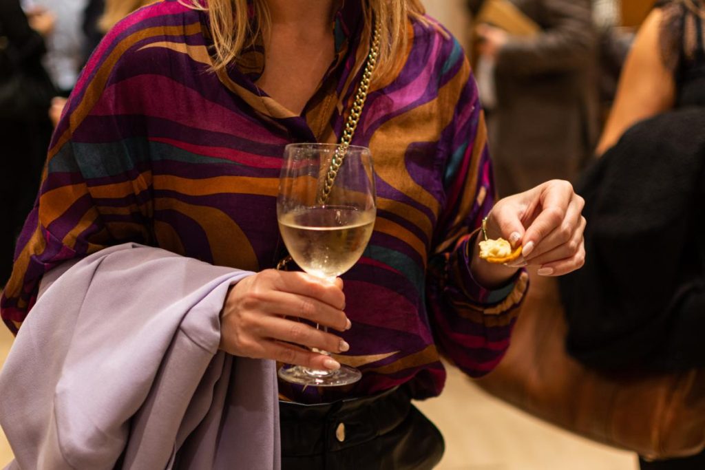 Woman holding cheese and wine