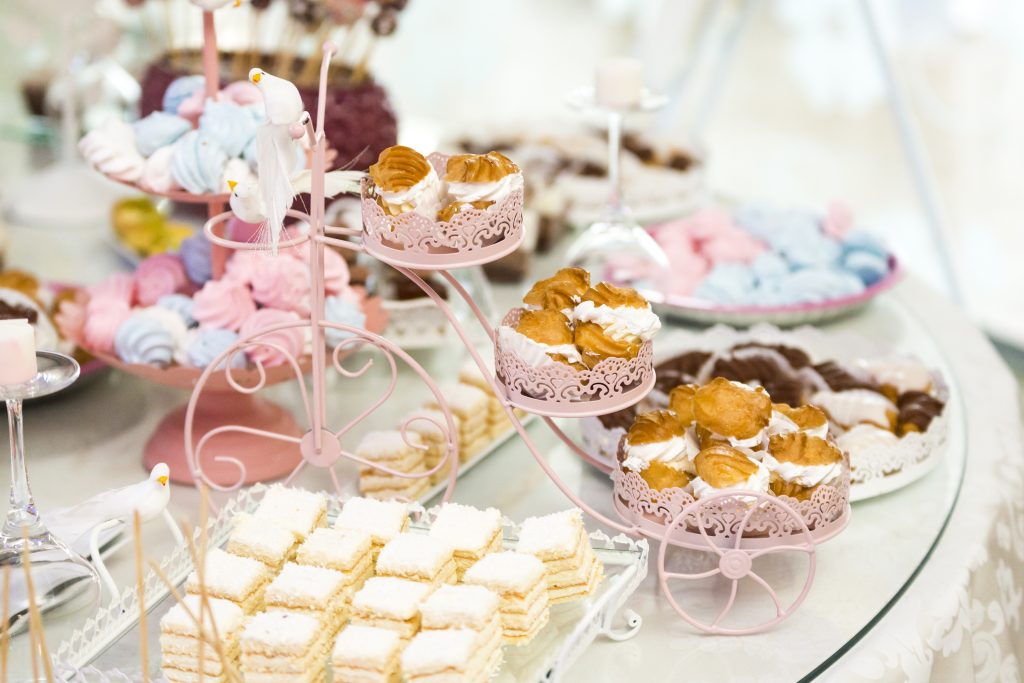 Dessert cups with chocolate and strawberry mousse by a catering service, elegantly displayed for a baptism event.